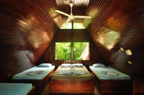 a bathroom with two sinks and a mirror at Howler Monkey Hotel in Montezuma