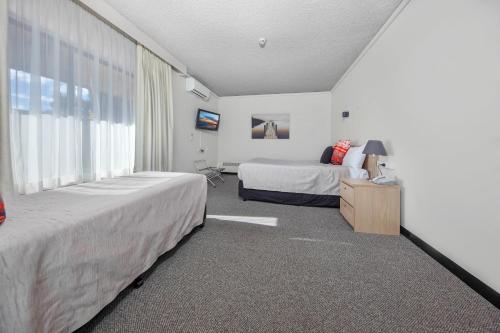a hotel room with two beds and a window at Belconnen Way Hotel & Serviced Apartments in Canberra