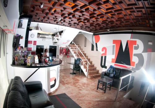 a room with a staircase and a table and chairs at Be Ramblas Guest House in Barcelona