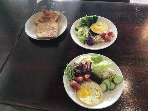three plates of breakfast food on a table at Locasu in Datong