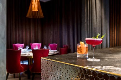 a bar with a drink on a counter in a restaurant at The Melbourne Hotel in Perth