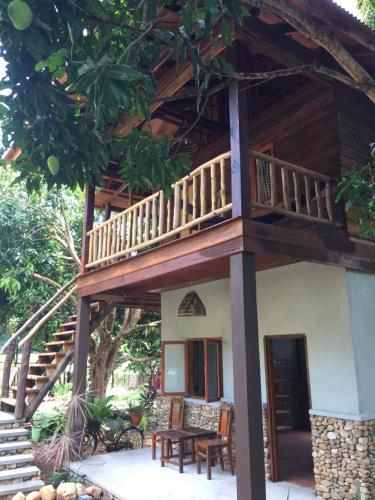 a house with a balcony and a table at Khmer Hands in Kep