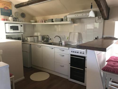 a kitchen with a sink and a stove top oven at The Annexe Croughton in Banbury