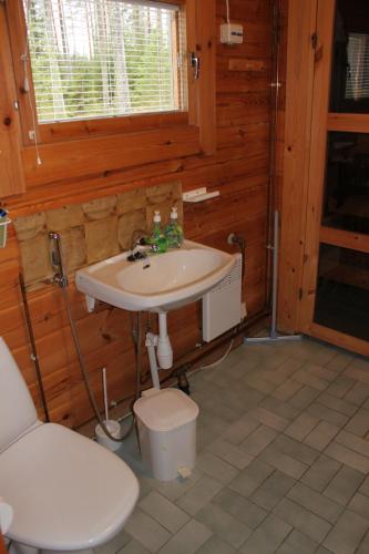 a bathroom with a sink and a toilet at Koskenranta in Heinävesi