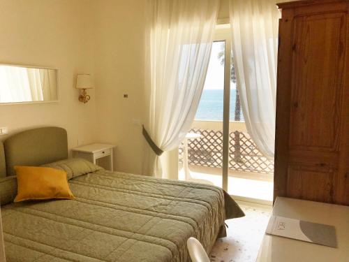 a bedroom with a bed and a view of the ocean at Villa Del Sole in Terracina