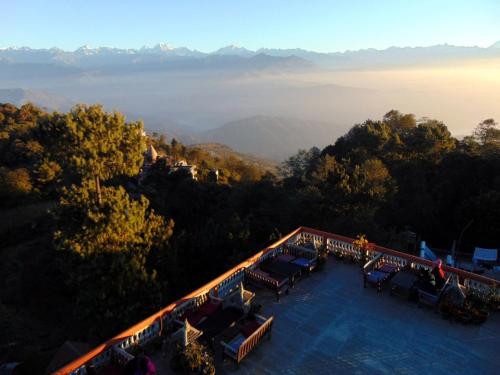 an aerial view of a resort with tables and chairs at Peaceful Cottage & Cafe Du Mont in Nagarkot