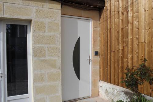 a white door on the side of a building at Etablissements Coulon - Talence (Chemin d'Ars) in Talence