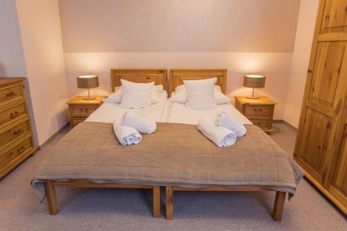 a bedroom with two beds with towels on them at Orlicka Skała in Zieleniec
