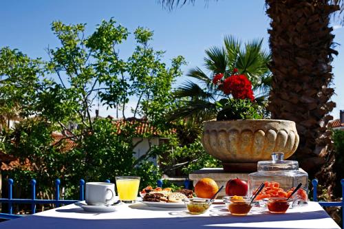 a table with food and a bowl of fruit on it at Stratos Hotel in Afitos