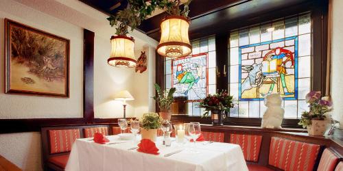 a table in a restaurant with stained glass windows at Hotel Fabritz in Essen