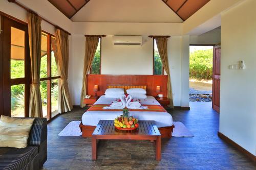 a bedroom with a large bed and a couch at Laya Safari Resorts & Spa in Yala