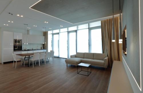 a living room with a couch and a table at Zala Springs Golf Resort in Zalacsány