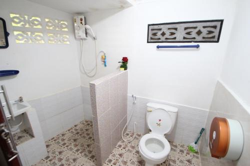 a bathroom with a white toilet and a shower at Pine Bungalow Krabi in Klong Muang Beach