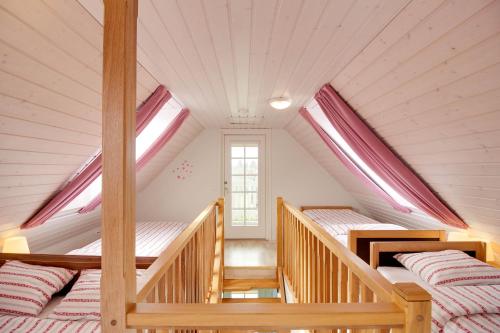 a bedroom with two beds in a attic at Kasekese Holiday Home with Sauna and Garden in Kuressaare