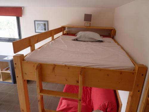 a wooden bunk bed in a small room at Studio Clos de Charance in Gap