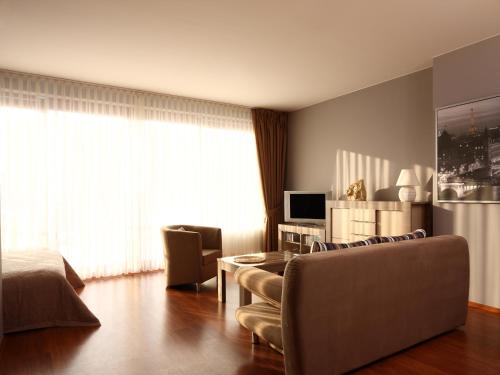 a living room with a couch and a table at Apartamenty Złota Nić in Opole