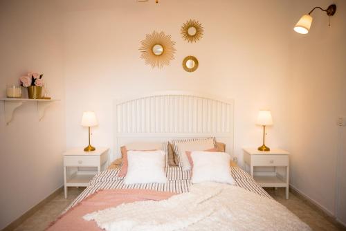 a bedroom with a bed with two night stands and two lamps at Sea View Apartment in Center of Las Americas in Playa de las Americas