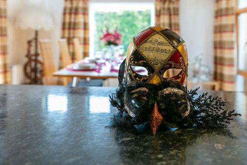 a mask sitting on top of a table at Sutton Cottage in Wexford