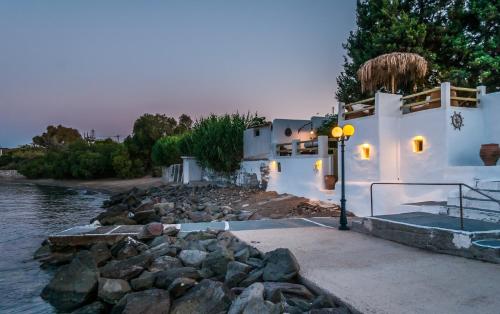 a white building with a street light next to a river at villa lord in Pollonia