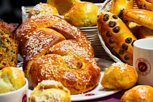 a bunch of pastries and breads on a table at Hôtel Le Père Léon in Toulouse