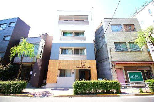 a building with a g sign in front of it at Sakura Cross Hotel Ueno Iriya in Tokyo