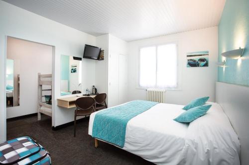 a hotel room with a bed and a desk and a bedroom at Hotel Les Dunes in La Tranche-sur-Mer