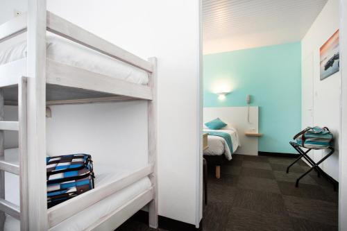 a small room with a bunk bed and a bedroom at Hotel Les Dunes in La Tranche-sur-Mer