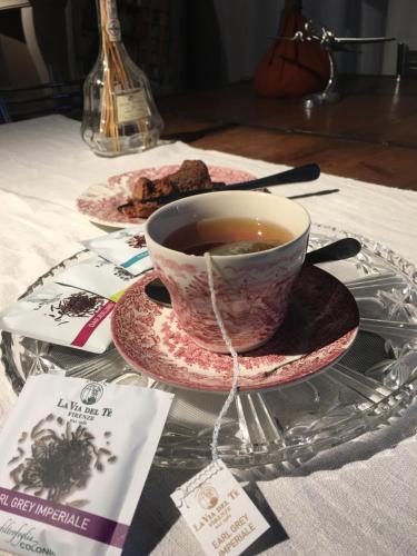 a cup of tea sitting on a glass table at Bed & Breakfast Il mio Gelso in Villanova dʼAsti