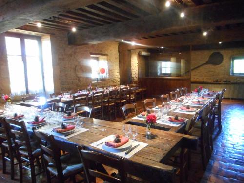 a large dining room with long tables and chairs at Chambre D' Hotes Des Collines in Amanzé