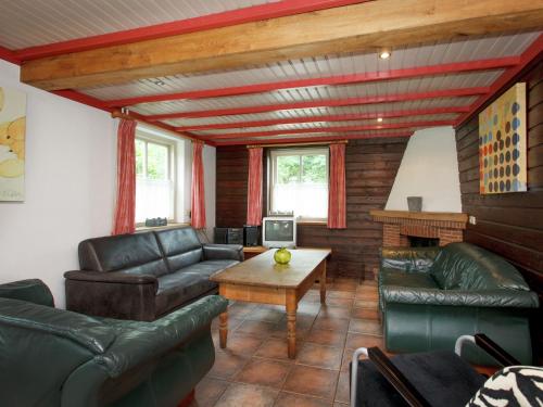 a living room with couches and a table at Beautiful Holiday Home in Lage Mierde with Fireplace in Lage Mierde