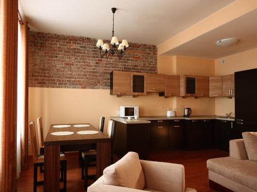 a kitchen and living room with a table and a dining room at Apartamenty Złota Nić in Opole