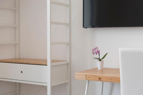 a white closet with shelves and a table at Lux in Naples