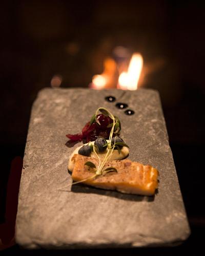 a piece of pizza sitting on top of a table at Bergstadens Hotel & Spa in Røros