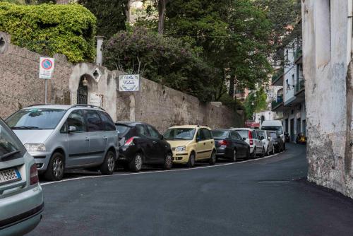 a row of cars parked on the side of a street at Hotel Villa Annalara charme and Relax in Amalfi