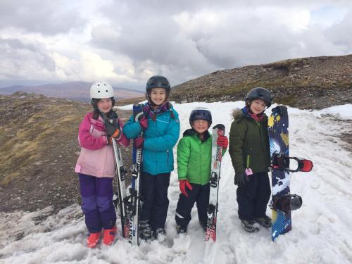 a group of people standing on top of a snow covered mountain at Mansefield House in Arrochar