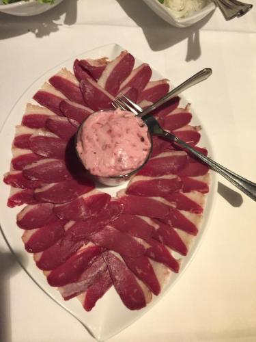 a plate with a bacon dessert on a table at Leuchtners an der Rennbahn in Iffezheim