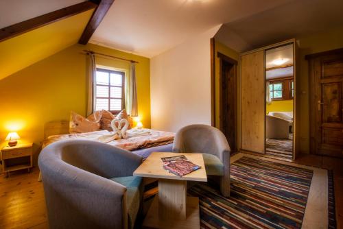 a bedroom with a bed and a table in a room at Chata Piecky in Hrabušice