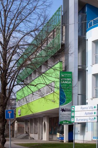 a building with a green facade on the side of it at Viiking Spa Hotel in Pärnu