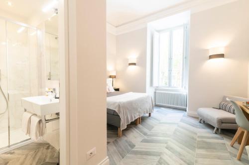Postel nebo postele na pokoji v ubytování Eccelso Hotel