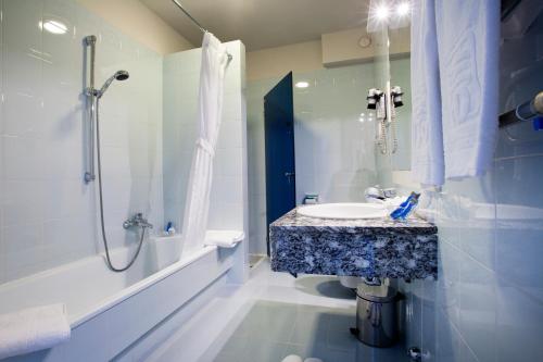 a bathroom with a sink and a shower at Hotel Desenzano in Desenzano del Garda