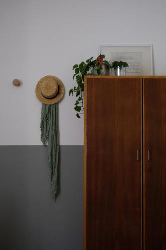 a hat on a wall next to a wooden cabinet at Casa Monteluro - B&b in Tavullia