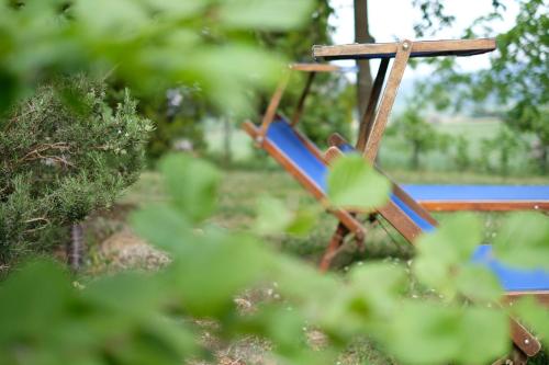 a blue swing sitting in the middle of a park at Casa Monteluro - B&b in Tavullia
