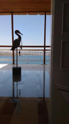 a statue of a bird standing in front of a window at Nostalgia Villas in Tersanas