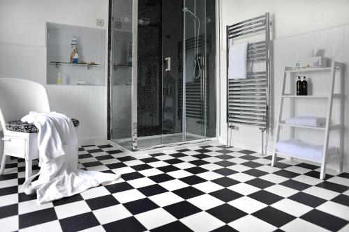 a bathroom with a shower and a checkered floor at Surf Haven in Bude