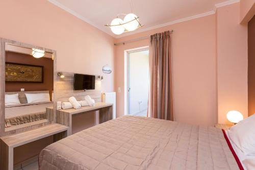 a hotel room with a bed and a window at Cozy Guest House in Rethymno Town