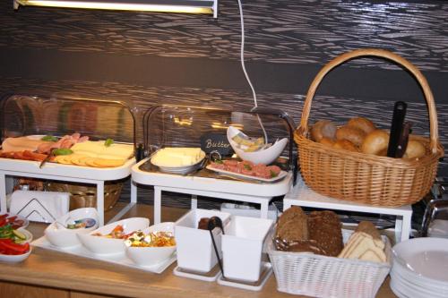 a buffet with different types of bread and other foods at Pension Heib in Cochem