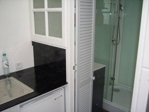 a bathroom with a shower and a white cabinet at Chalet indépendant proche centre ville in Le Mans