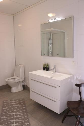 a bathroom with a white sink and a toilet at Valldal Gjestgiveri in Valldal