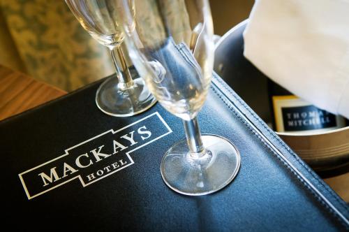 two wine glasses sitting on top of a black box at Mackays Hotel in Wick