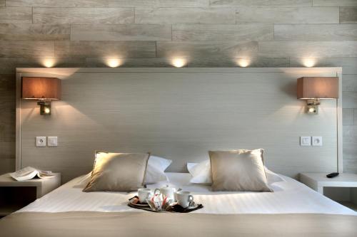 a bedroom with a bed with a tray on it at Seventeen Hotel in Valbonne